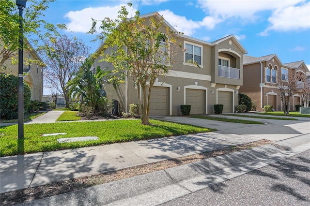 8835 Moonlit Meadows Loop, Riverview, FL 33578 - townhome / multi-family property featuring stucco siding, an attached garage, driveway, and a front lawn