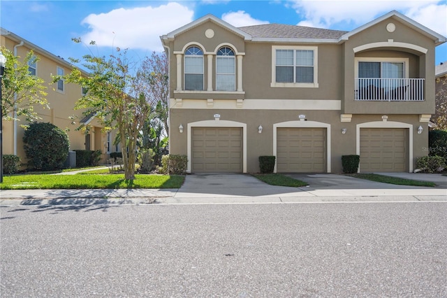 8835 Moonlit Meadows Loop, Riverview, FL 33578 - townhome / multi-family property with stucco siding, an attached garage, and driveway