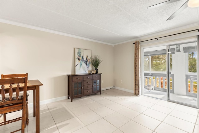 tiled dining area with ceiling fan, ornamental molding, and a textured ceiling