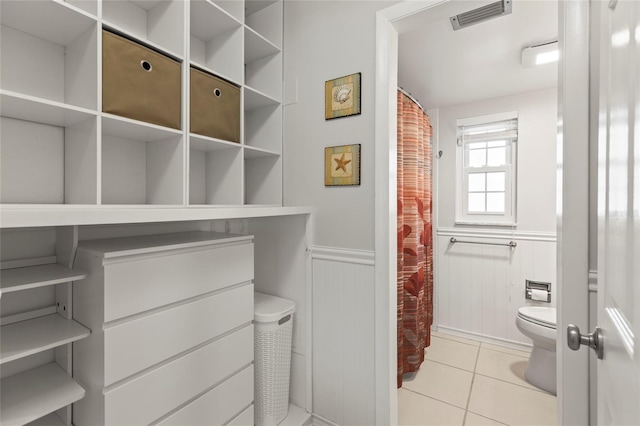 bathroom featuring tile patterned floors and toilet