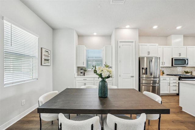 dining area with dark hardwood / wood-style flooring