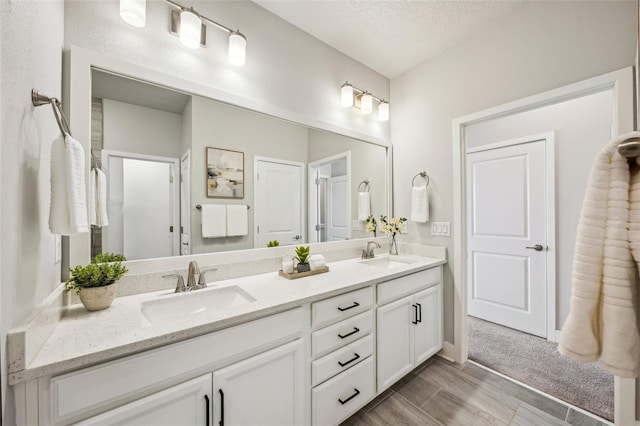 bathroom featuring vanity and a textured ceiling