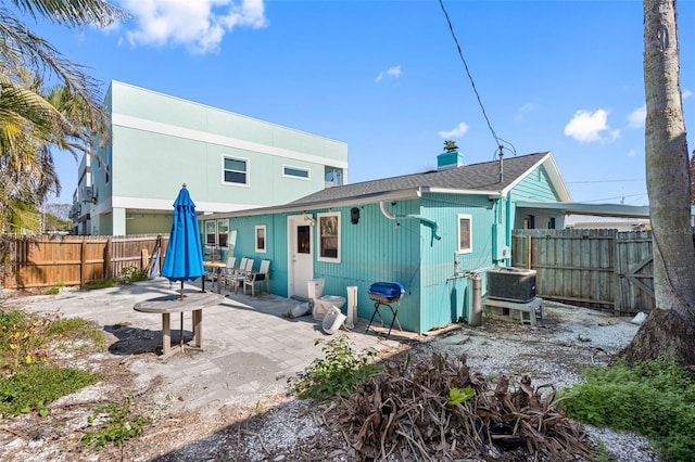 rear view of property featuring cooling unit and a patio