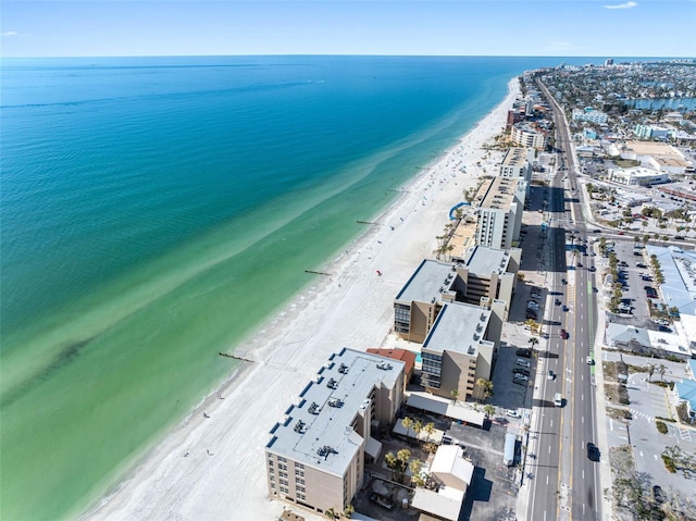 birds eye view of property with a beach view and a water view