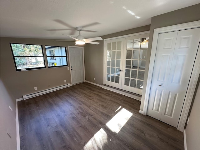 interior space featuring french doors, baseboard heating, a ceiling fan, wood finished floors, and baseboards