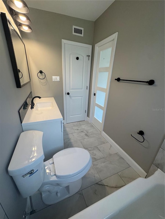 bathroom featuring visible vents, marble finish floor, a sink, and toilet