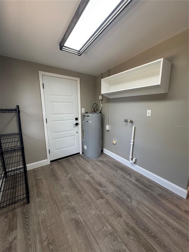 laundry room with laundry area, baseboards, dark wood-style floors, water heater, and washer hookup