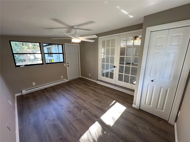 unfurnished room featuring a baseboard radiator, ceiling fan, wood finished floors, and french doors