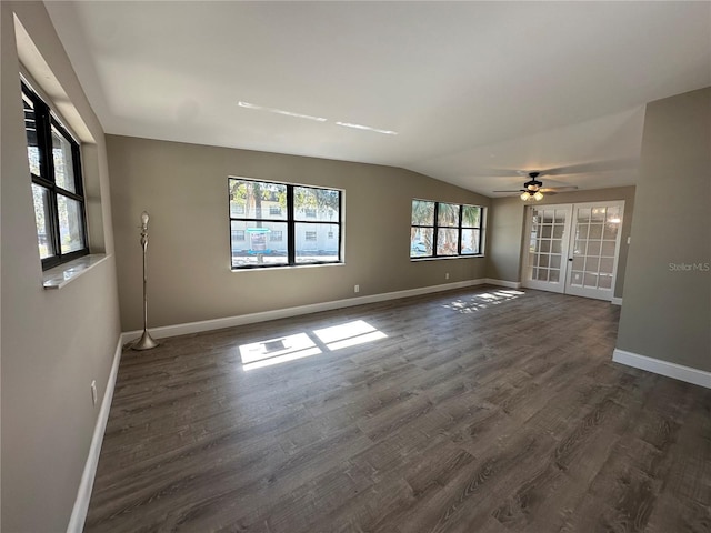 unfurnished room featuring french doors, lofted ceiling, baseboards, and dark wood finished floors