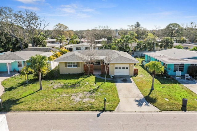 ranch-style home with a garage and a front lawn