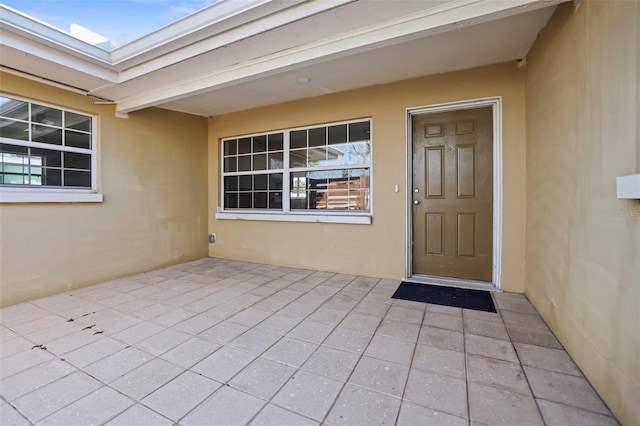 property entrance featuring a patio area