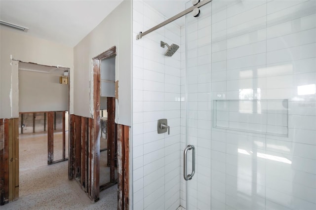 bathroom featuring a shower with shower door