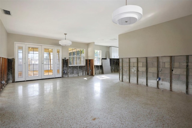 unfurnished living room with french doors