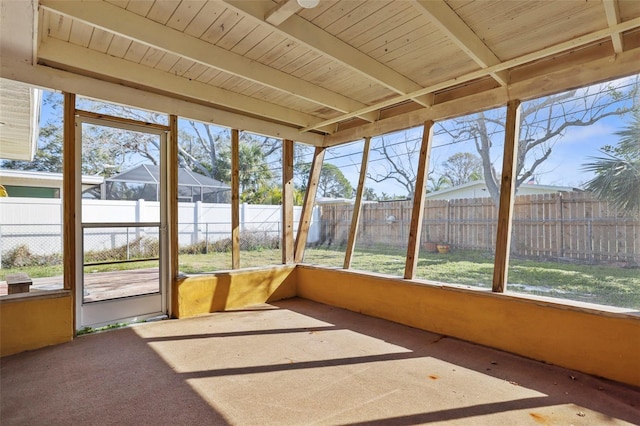 unfurnished sunroom with beam ceiling and wooden ceiling