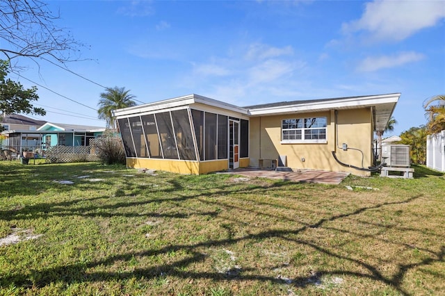 back of house featuring a patio, a sunroom, and a yard