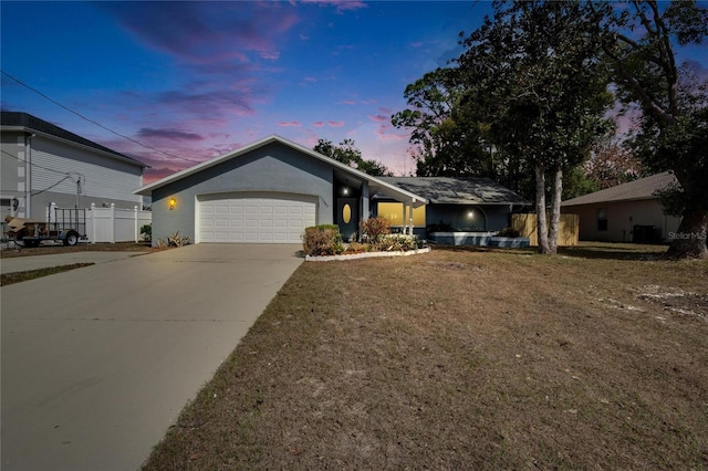 view of front of property featuring a garage and a yard