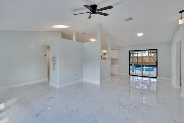 spare room featuring ceiling fan and vaulted ceiling