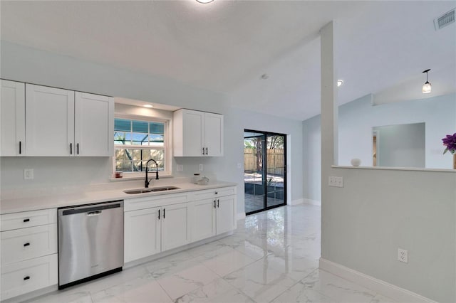 kitchen featuring sink, white cabinetry, vaulted ceiling, stainless steel dishwasher, and pendant lighting