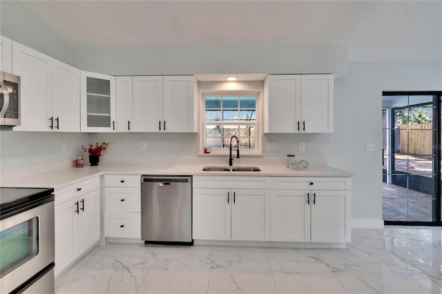 kitchen with white cabinetry, appliances with stainless steel finishes, sink, and plenty of natural light