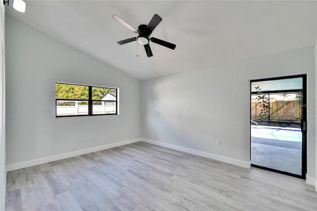 spare room featuring lofted ceiling, light hardwood / wood-style flooring, and ceiling fan