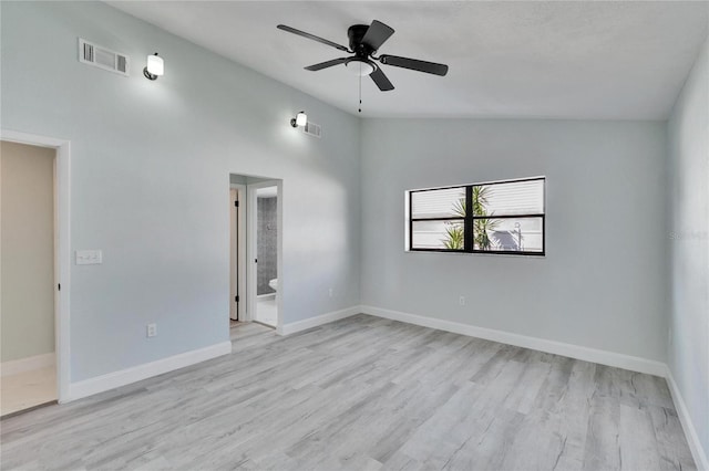 empty room featuring vaulted ceiling, ceiling fan, and light wood-type flooring