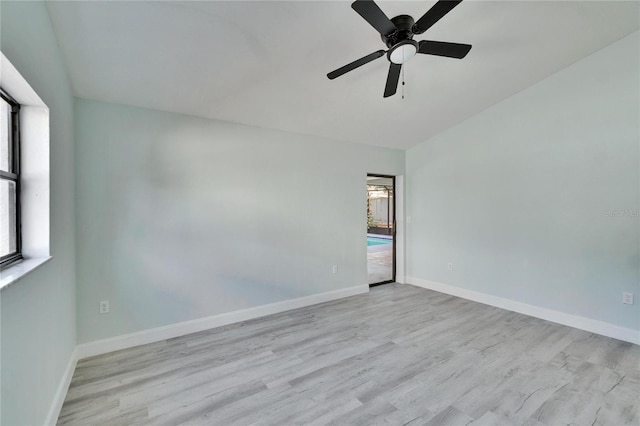 spare room with ceiling fan and light wood-type flooring