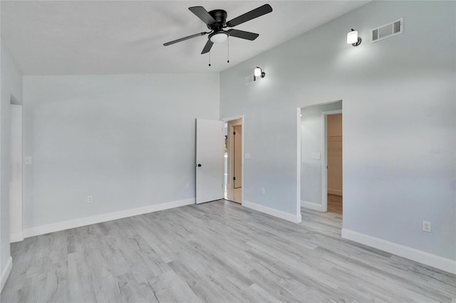 spare room featuring ceiling fan, high vaulted ceiling, and light hardwood / wood-style floors