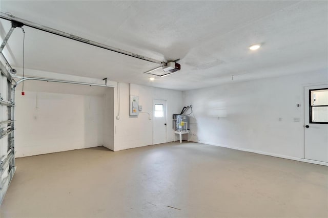 garage featuring a garage door opener, electric panel, and water heater