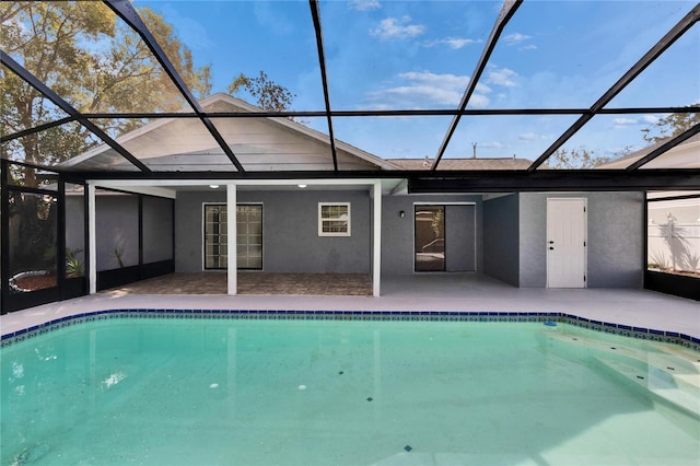 view of pool featuring a patio and glass enclosure