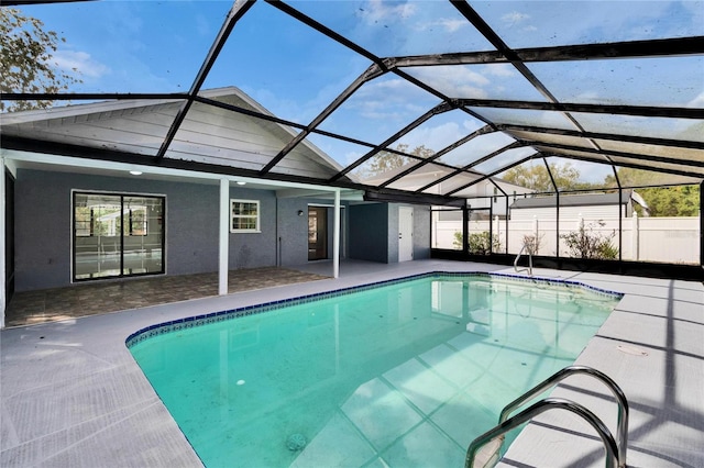 view of swimming pool featuring a patio and glass enclosure