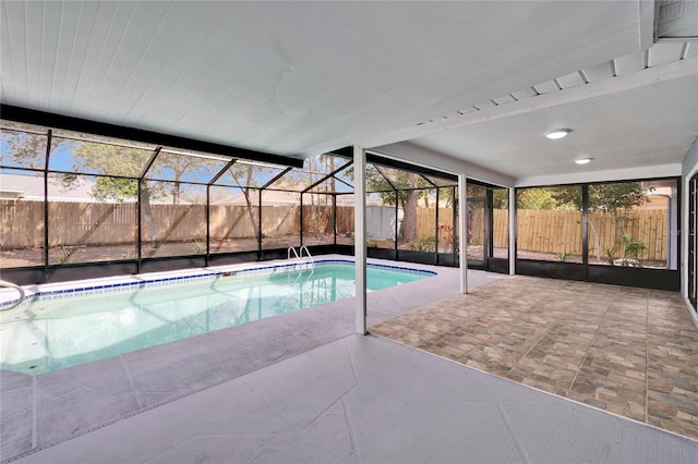 view of pool with a patio and a lanai