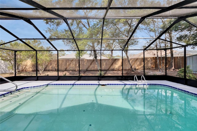 view of swimming pool featuring a lanai