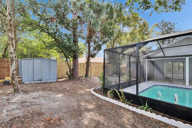 view of yard featuring a storage shed, a patio, a fenced in pool, and glass enclosure