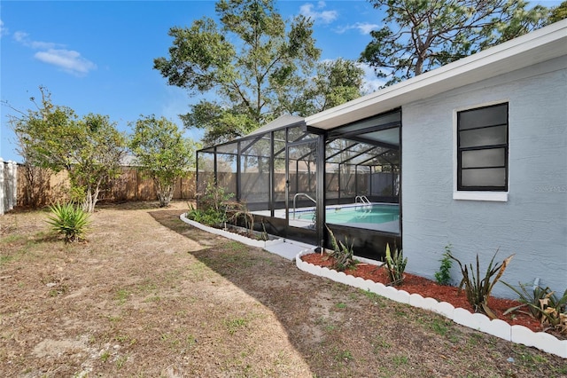 view of yard featuring a fenced in pool and a lanai