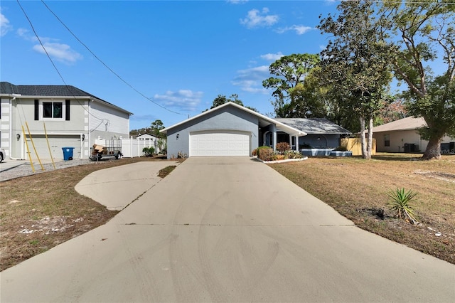 view of front of property with a garage and a front lawn