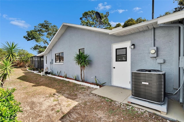 doorway to property featuring central air condition unit