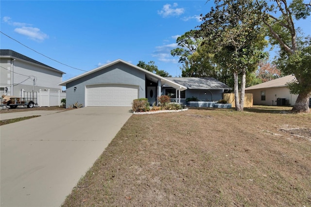 single story home with a garage, a front yard, and central air condition unit