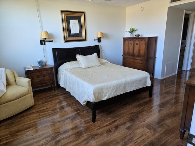 bedroom with dark hardwood / wood-style flooring