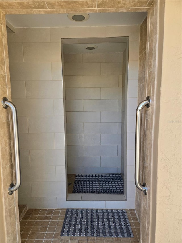 bathroom featuring a shower with door