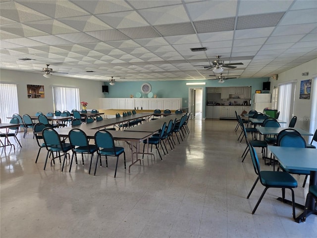 dining space featuring a paneled ceiling and ceiling fan