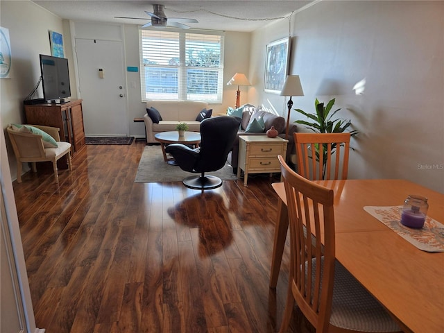 interior space featuring a textured ceiling, dark wood-type flooring, and ceiling fan