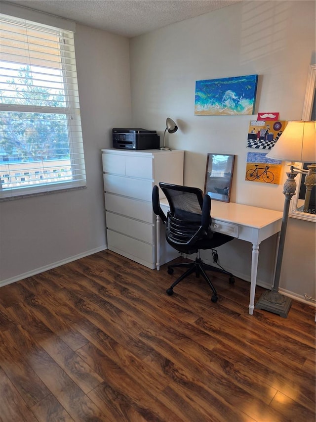 office with dark wood-type flooring and a textured ceiling