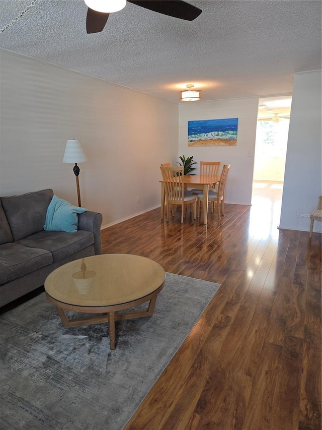 4915 Bay St NE Unit 322, Saint Petersburg, FL 33703 - living area featuring a ceiling fan, wood finished floors, and a textured ceiling