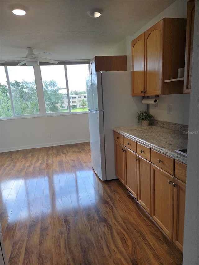 4915 Bay St NE Unit 322, Saint Petersburg, FL 33703 - kitchen featuring a ceiling fan, dark wood-style floors, baseboards, light stone countertops, and recessed lighting