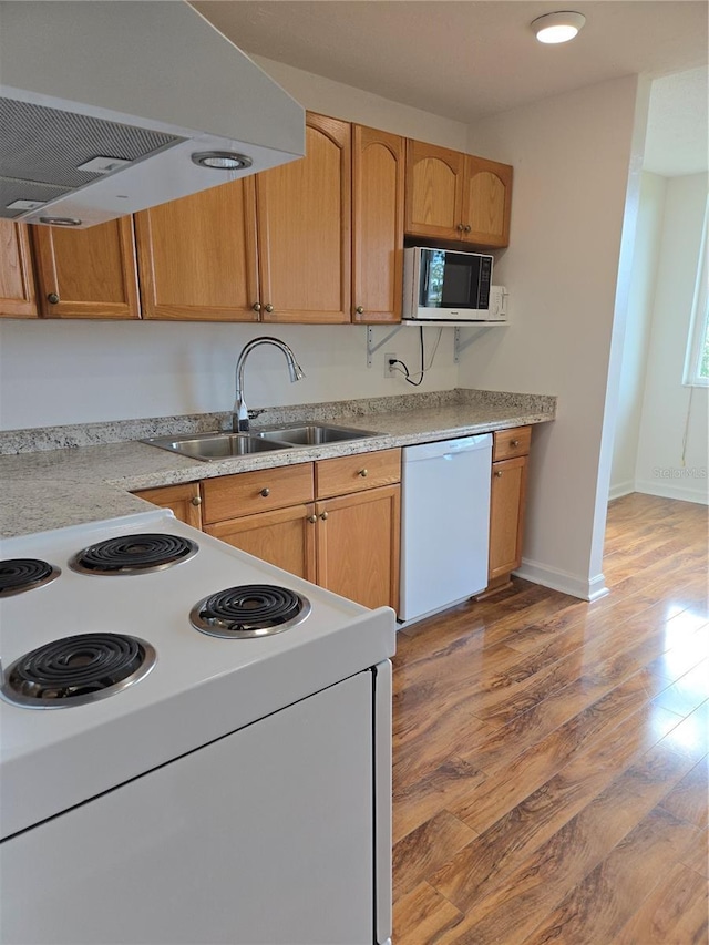 4915 Bay St NE Unit 322, Saint Petersburg, FL 33703 - kitchen with white appliances, exhaust hood, light wood-style floors, a sink, and light countertops