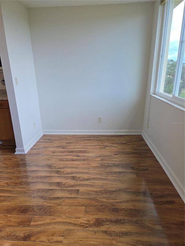 4915 Bay St NE Unit 322, Saint Petersburg, FL 33703 - spare room featuring dark wood-style flooring and baseboards
