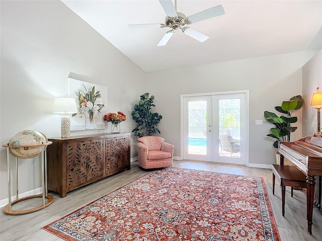 living area with hardwood / wood-style flooring, lofted ceiling, ceiling fan, and french doors