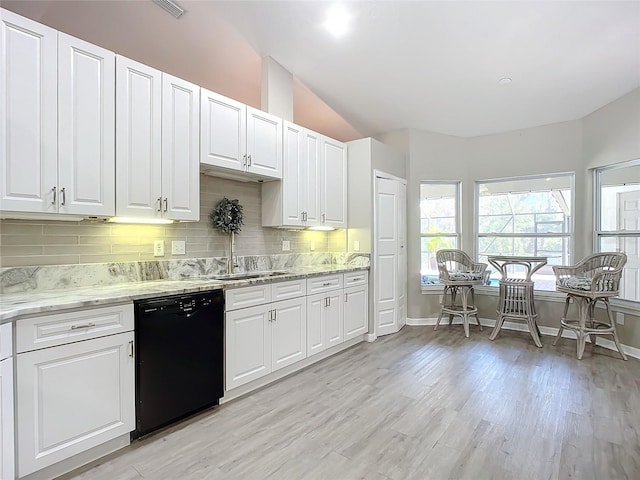 kitchen with black dishwasher, sink, and white cabinets