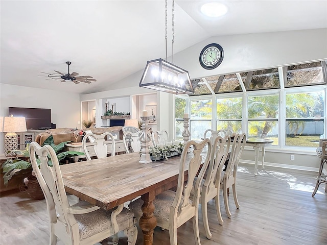 dining area with vaulted ceiling, hardwood / wood-style floors, and ceiling fan