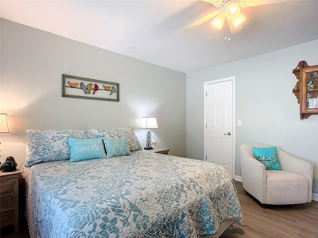 bedroom with hardwood / wood-style flooring and ceiling fan